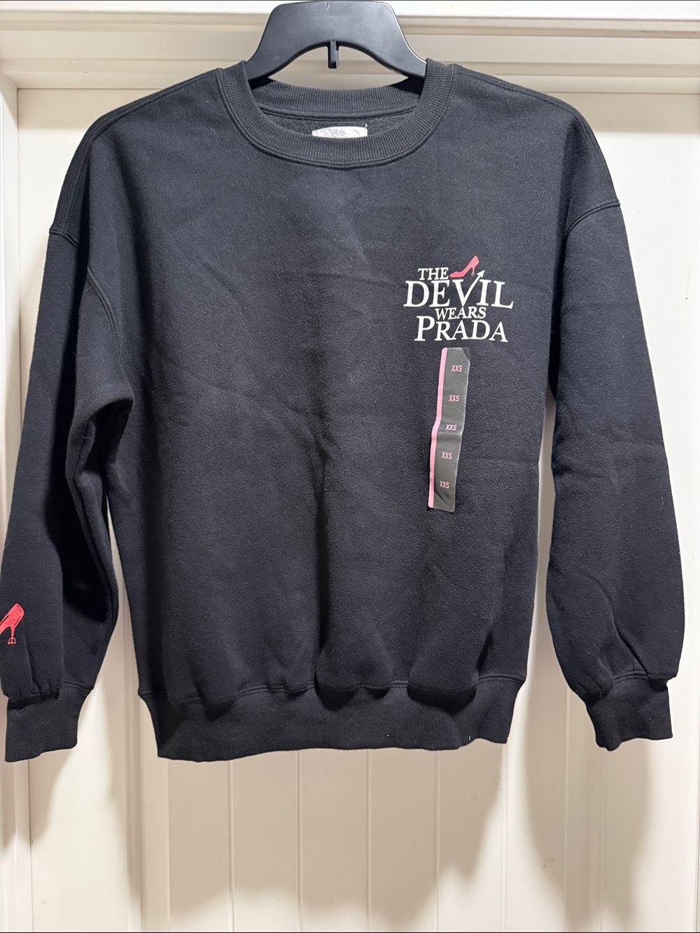 The Devil Wears Prada Black Crewneck Sweatshirt with Pink Logo and Heel Accent